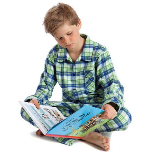 Otto reading on the floor in green check pyjamas